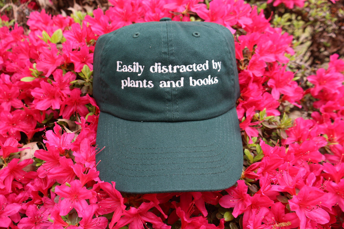 Easily distracted by plants and books Embroidered Dad Hat | Custom Cotton Baseball Cap | Adjustable Classic Hat